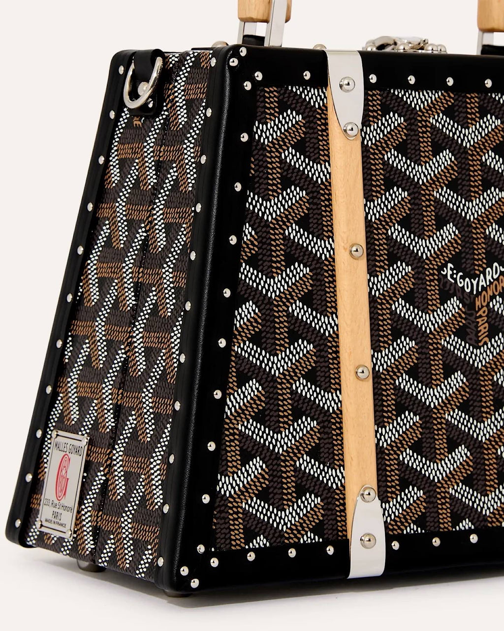 Close-up detail of Goyard Saïgon Mini Trunk Bag 3N highlighting Goyardine canvas, beechwood handle and trunk-inspired design.