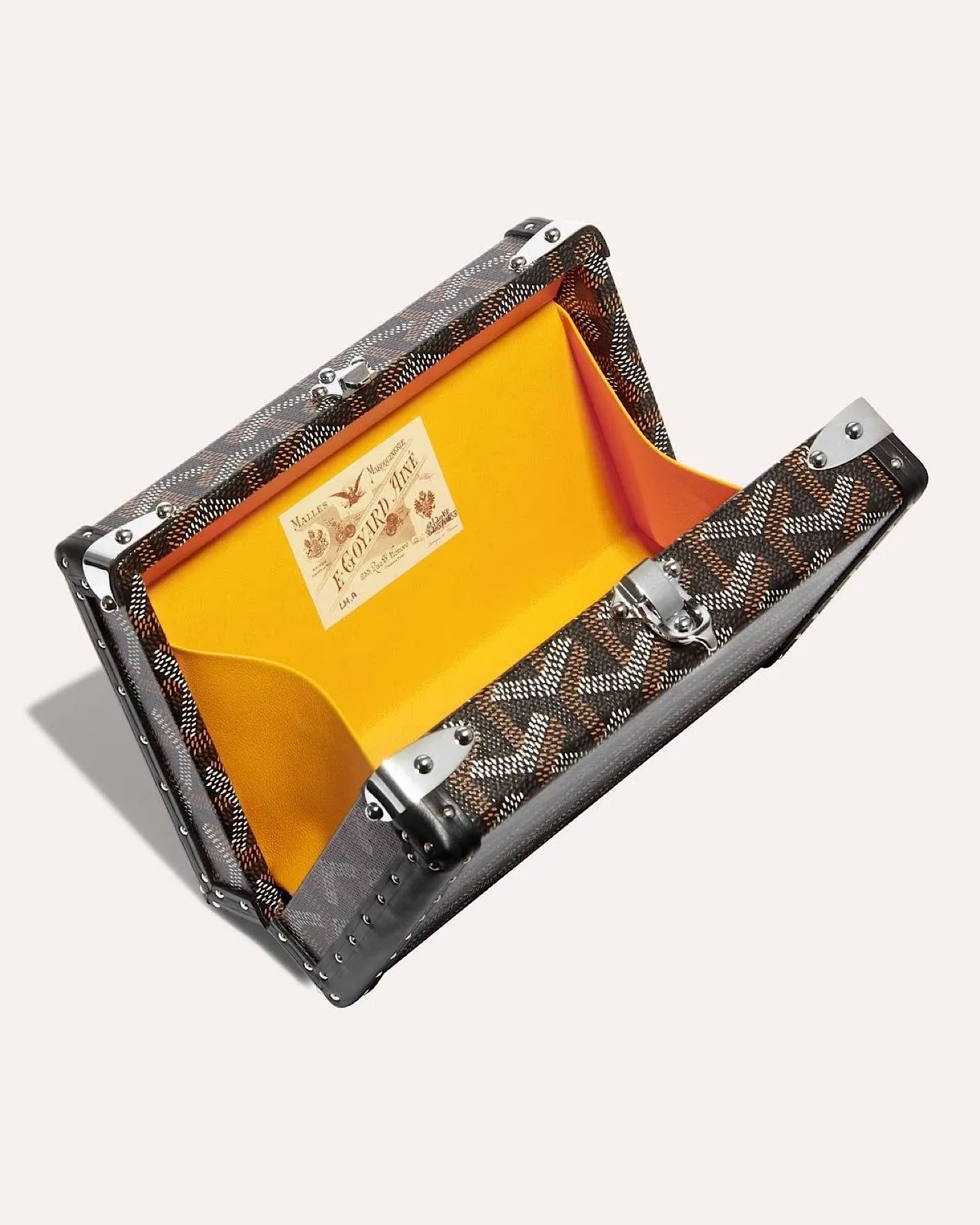 Goyard Minaudière Trunk Bag in black and grey Goyardine canvas with palladium hardware, leather trim, detachable shoulder strap, and signature trunk-inspired design.