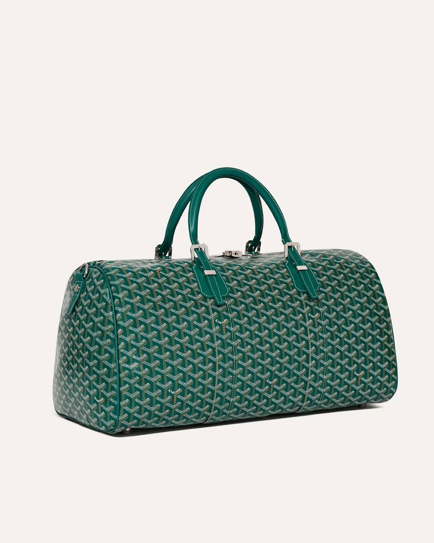 Side view of the Goyard Boston 50 travel bag in Green with leather handles.