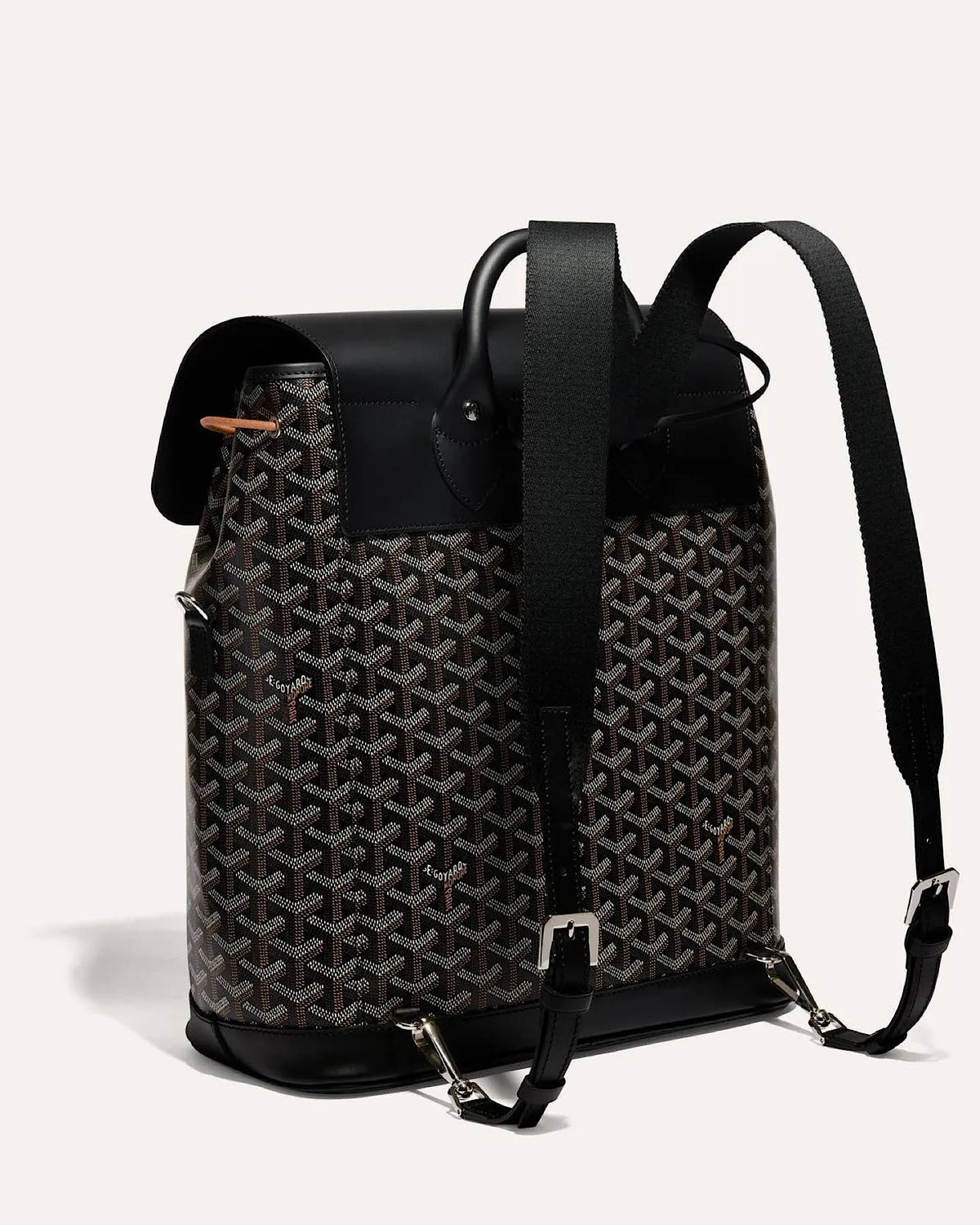 Side view of the Goyard Alpin MM Backpack in Black with adjustable leather shoulder straps.
