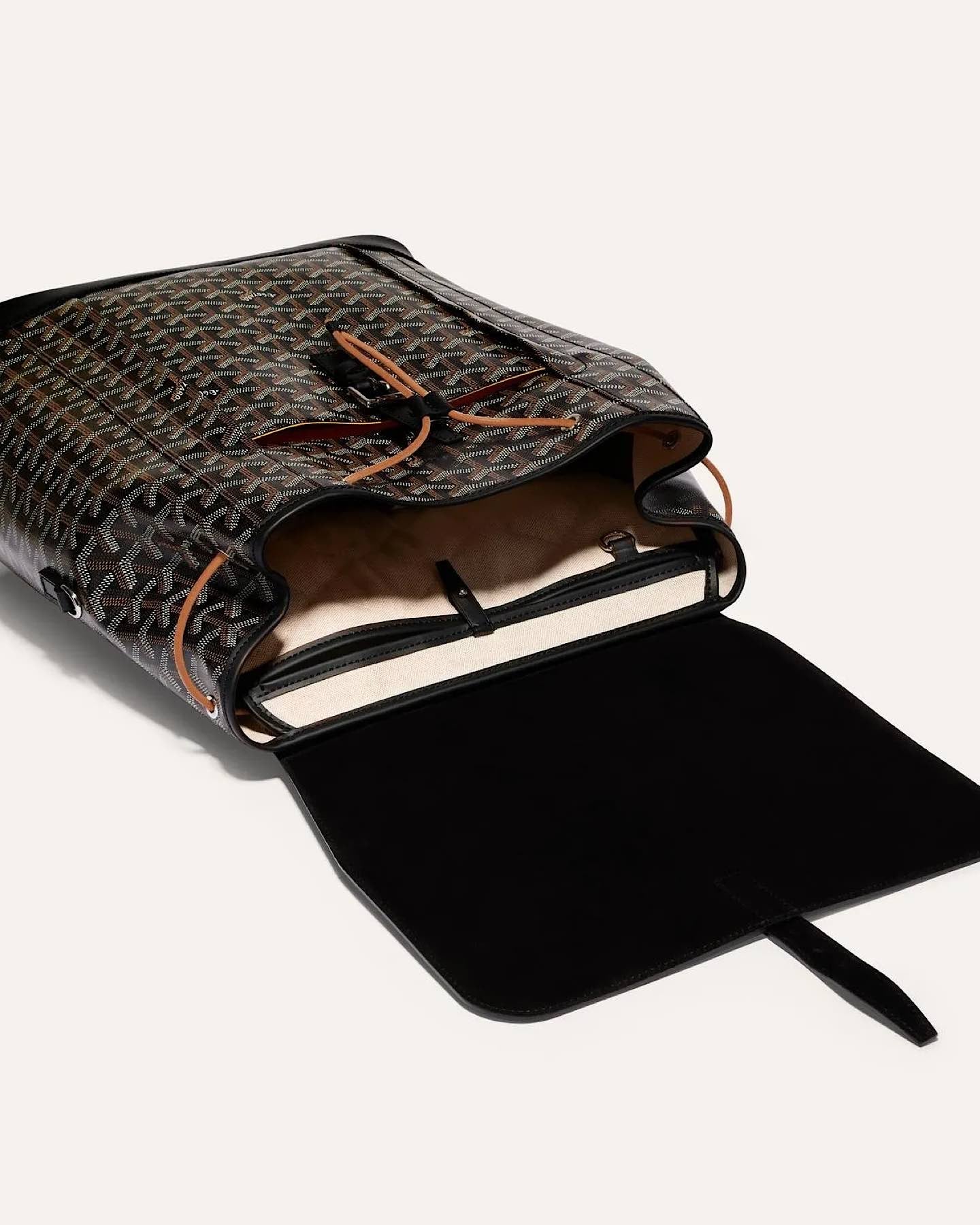 Close-up of the Goyard Alpin MM Backpack showcasing the iconic Goyardine pattern and leather flap.