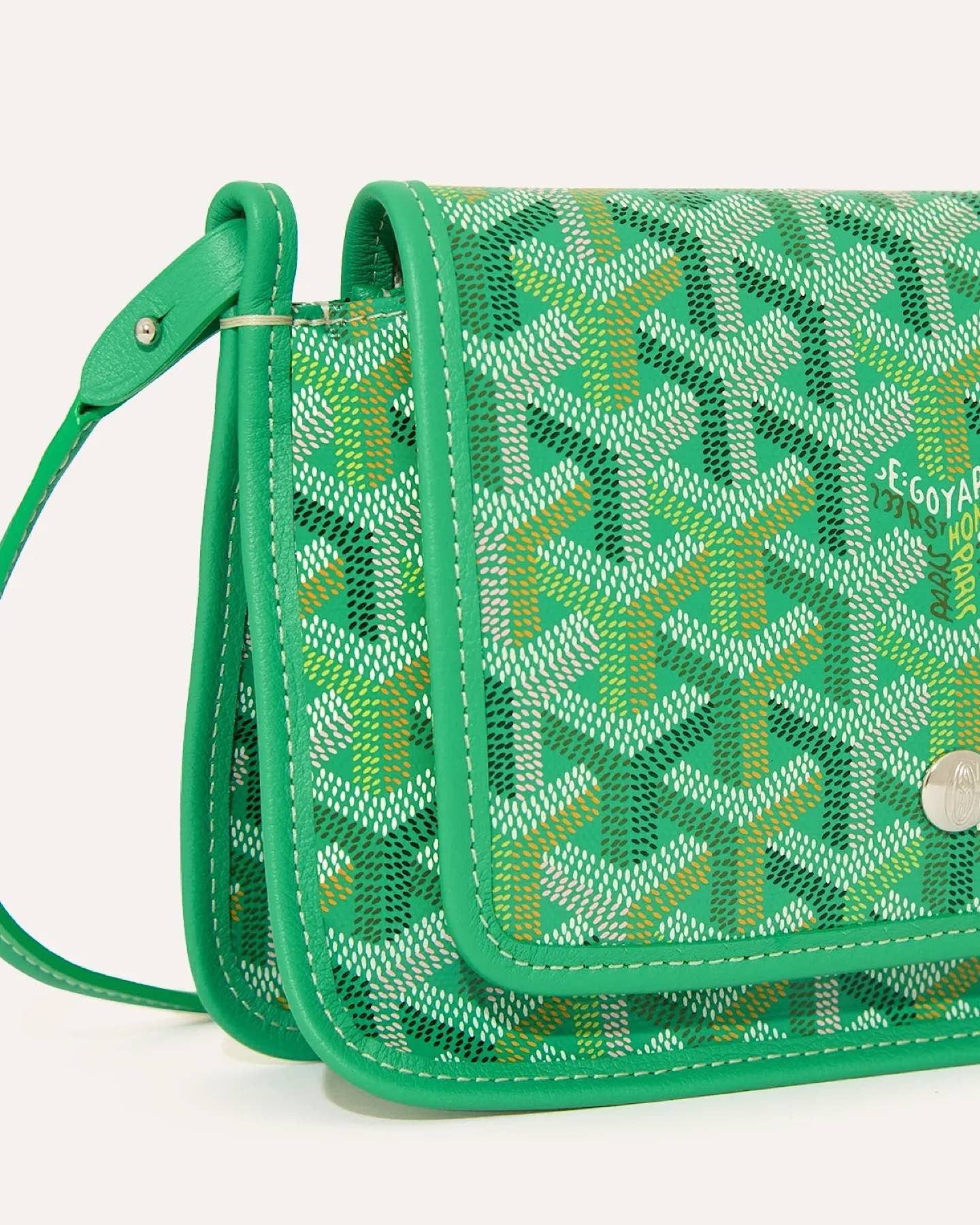 Side view of the Goyard Plumet Pouch Wallet in Multicolored Green with adjustable leather shoulder strap.