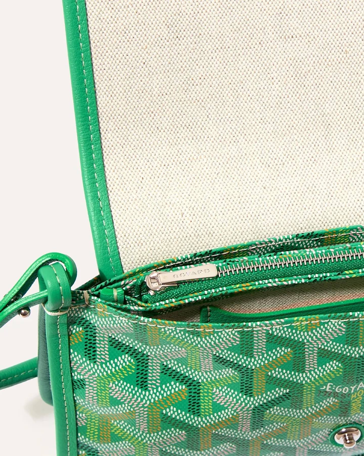 Close-up of the Goyard Plumet Pouch Wallet featuring the iconic Goyardine pattern, leather trim, and interior compartment.