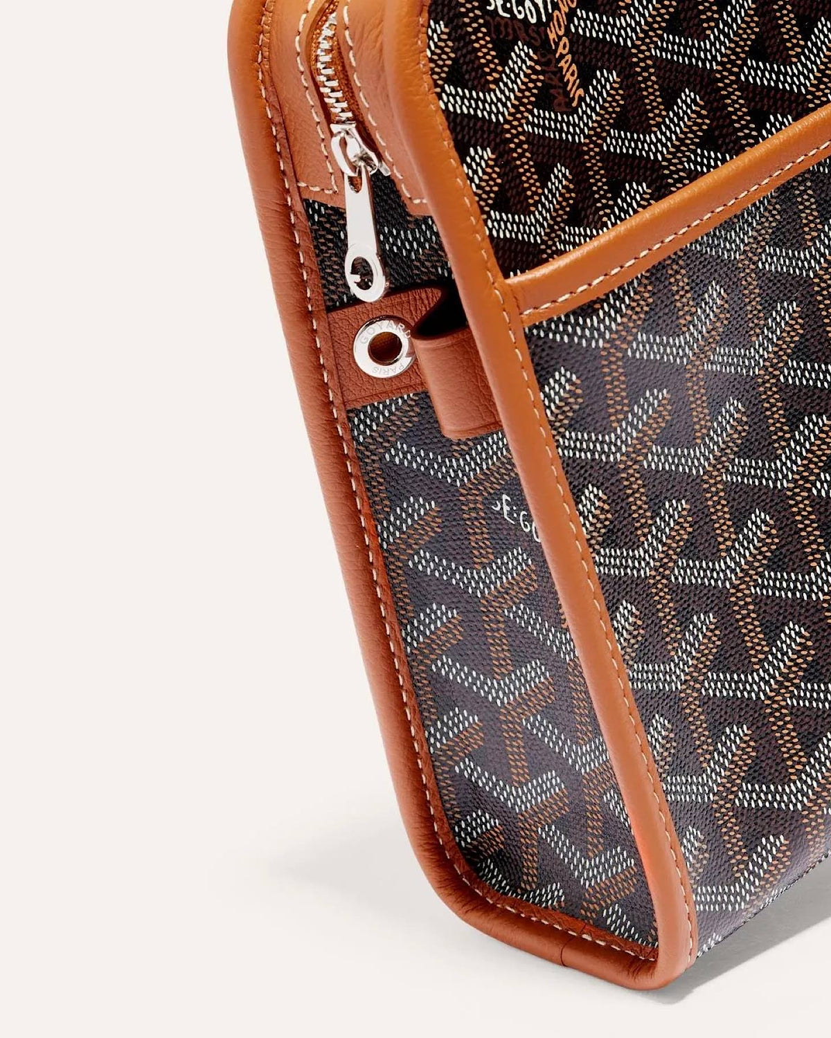 Close-up of the brown Goyard Jouvence MM cosmetic pouch featuring iconic Goyardine canvas pattern